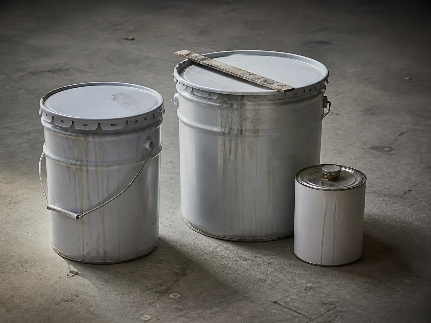 A single sealed binder pail beside a two part kit