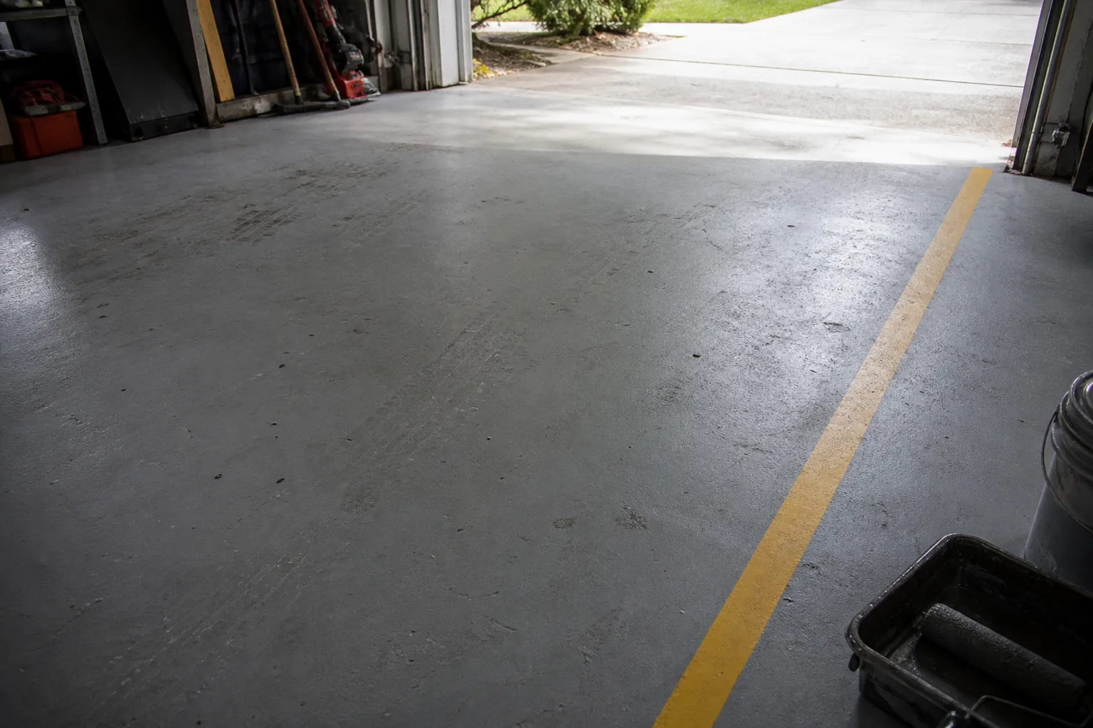 Painted concrete garage floor with a yellow safety line