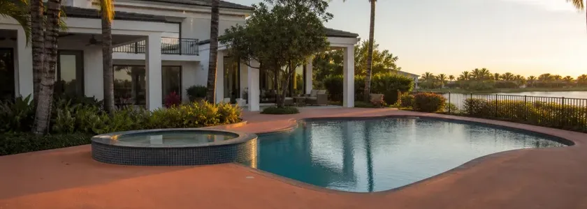 Florida villa with a rubber pool deck at sunset