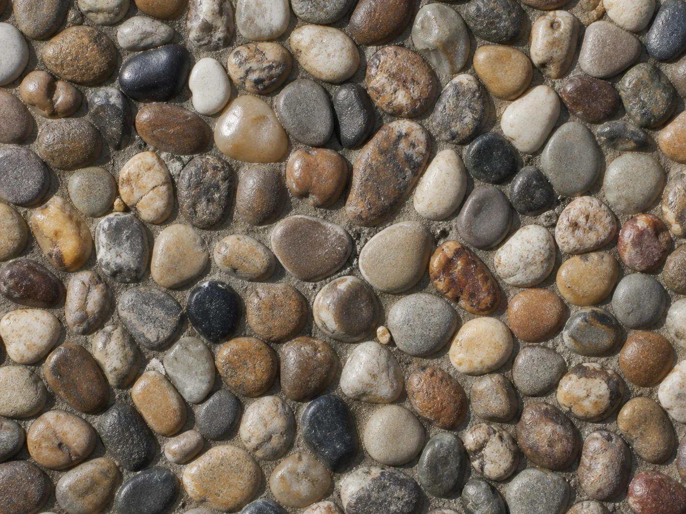 Finished pebble stone carpet surface with clear resin holding the stone